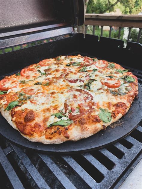 cooking pizza on a stone on the grill